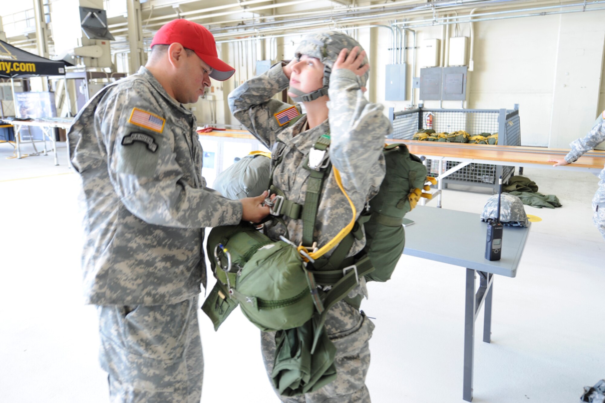 JOINT BASE ELMENDORF-RICHARDSON,Alaska-Army Staff Sergeant Eugenio Gonzales, 4th Quartermaster Det, inspects parachute rig of Private Fiirst Class Jennifer Hess, 425 HHC, during  Arctic Thunder Open House held at Joint Base Elmendorf-Richardson on 28-29 July.   (USAF Photo by Steven White/JBER/PA)
