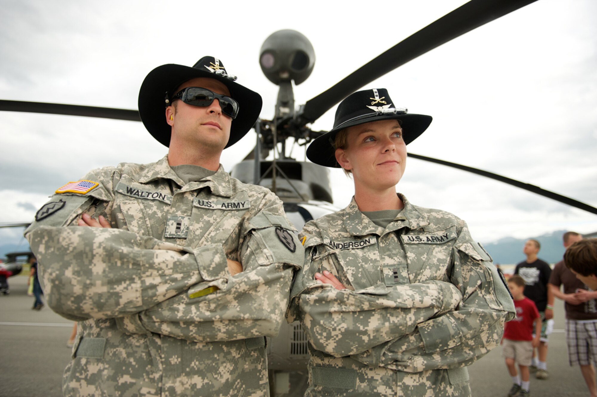 JOINT BASE ELMENDORF-RICHARDSON, Alaska -- Chief Warrant Officer 2 Mike Walton and Chief Warrant Officer 2 Adrienne Anderson, both OH-58D Kiowa pilots of 6th Squadron, 17th Cavalry Regiment, Fort Wainwright, Alaska, stand ready to answer questions about their armed-reconaissance helicopter July 28 during the Arctic Thunder 2012 Open House here. (U.S. Air Force photo/David Bedard)