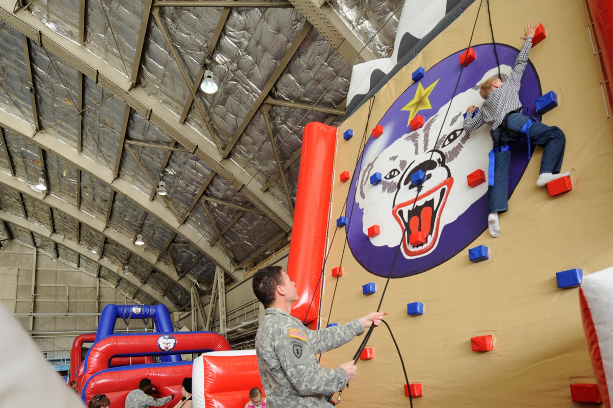 JOINT BASE ELMENDORF-RICHARDSON,Alaska- Army Specialist Marvin Turner, 40th Cav,  provided guiudane and safety to young wall climbers during   Arctic Thunder Open House held at Joint Base Elmendorf-Richardson on 28-29 July.   (USAF Photo by Steven White/JBER/PA)