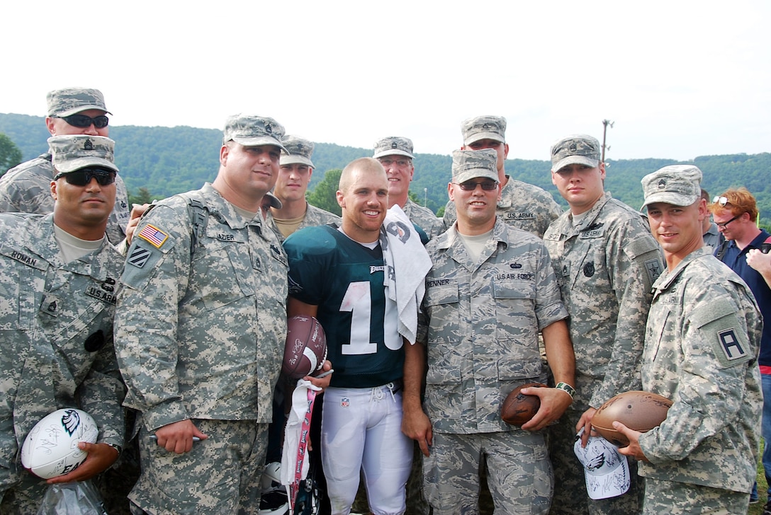 Service members pose with Philadelphia Eagles wide receiver Chad Hall during the Eagles training camp at the Air Force Academy, Colo., Aug.1, 2012. The troops helped Hall shave his head in honor of those who serve in the military.
(U.S. Army photo/Capt. Antonia Greene)
