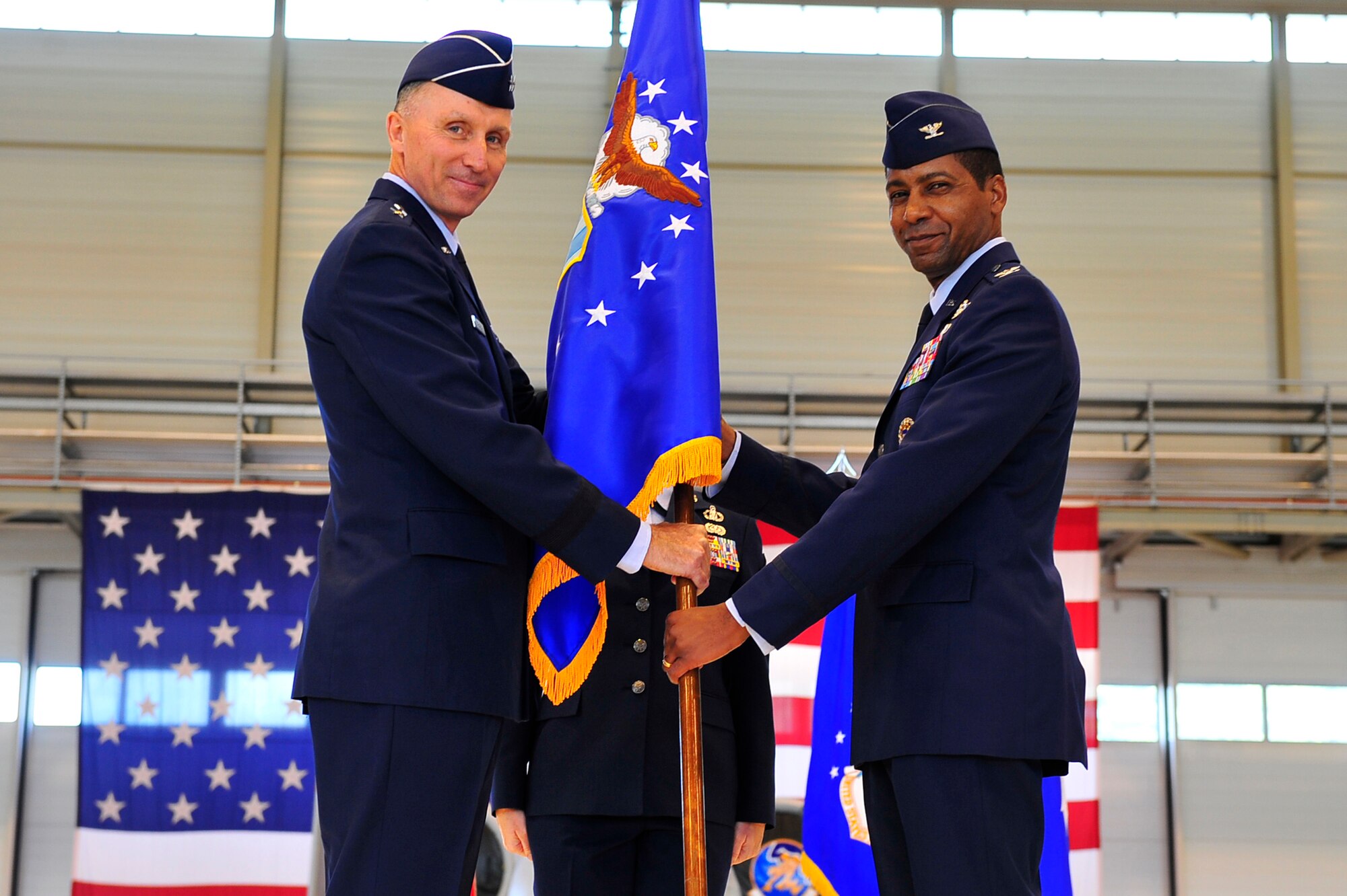 U.S. Air Force Maj. Gen. William J. Bender gives Col. Randall Reed, command of the 521st Air Mobility Operations Wing during a change of command ceremony on Ramstein Air Base, Germany, July 30, 2012. Col. Reed is a command pilot with more that 3,300 flying hours. Before coming to Ramstein, he served as commander of the 379th Expeditionary Operations Group in Southwest Asia. The 521st AMOW provides en-route services: aircraft maintenance, aerial port and command and control, in Europe, southwest and central Asia and northern Africa. The wing has personnel spread across 19 bases in 13 different countries. (U.S. Air Force photo by Staff Sgt. Tyrona Lawson)