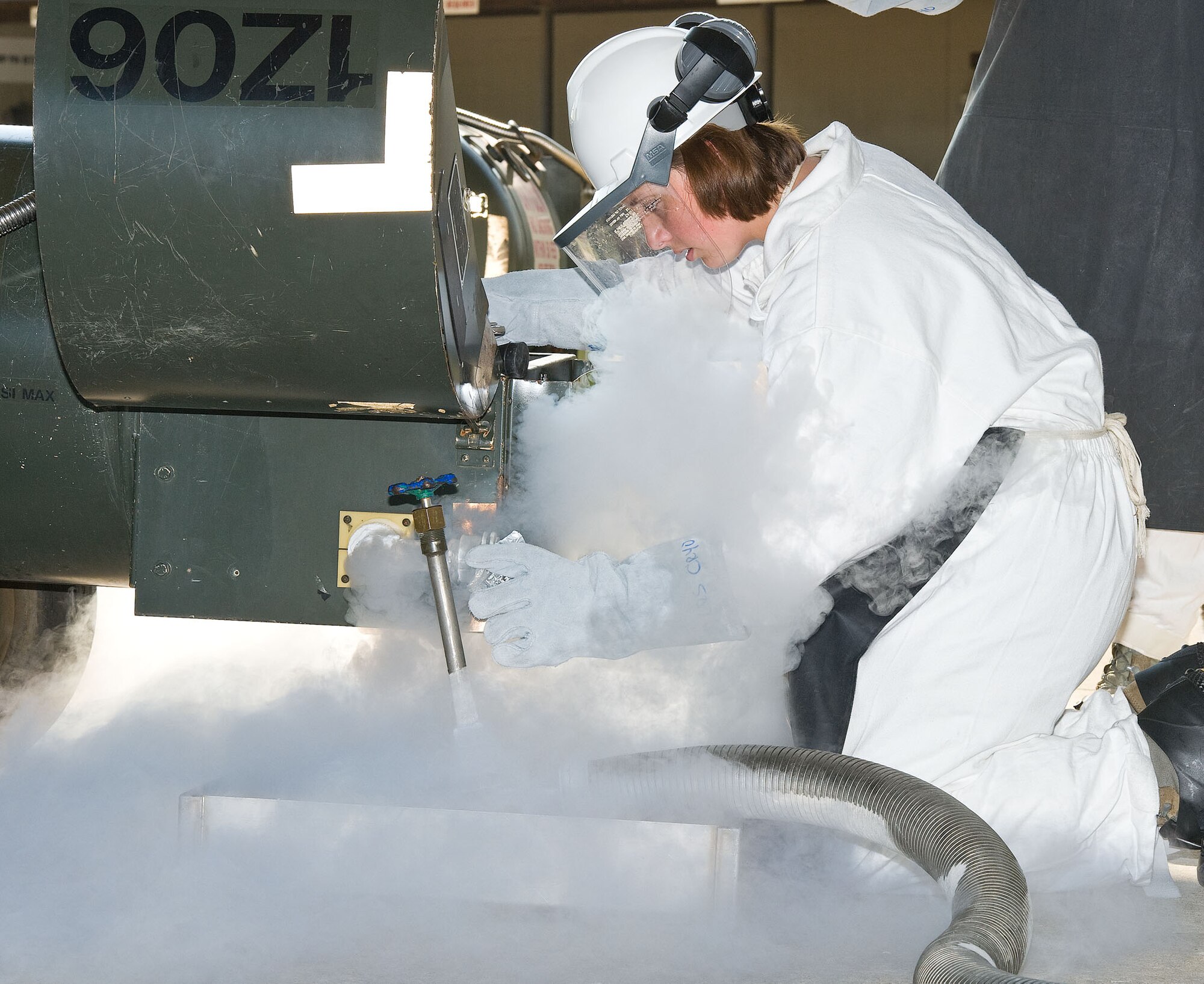 Airman Mackenzie Newman, a cryogenics facilities specialist with the 436th Logistics Readiness Squadron, takes a sample from a liquid oxygen cart in the cryogenics servicing yard Aug. 2, 2012, at Dover Air Force Base, Del. Samples are taken to test the liquid oxygen for impurities.  (U.S. Air Force photo by Roland Balik)