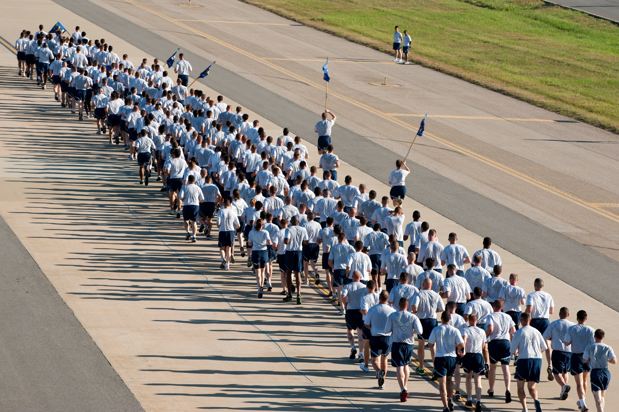 Members of the 8th Fighter Wing participate in the first Warrior Run since change of command season with  Col. Douglas Nikolai, 8th FW vice wing commander, at Kunsan Air Base, Republic of Korea, August 03, 2012. The Airmen ran 2.6 miles on the flight line while they sang jodies and built camaraderie. (U.S. Air Force photo/Senior Airman Marcus Morris)