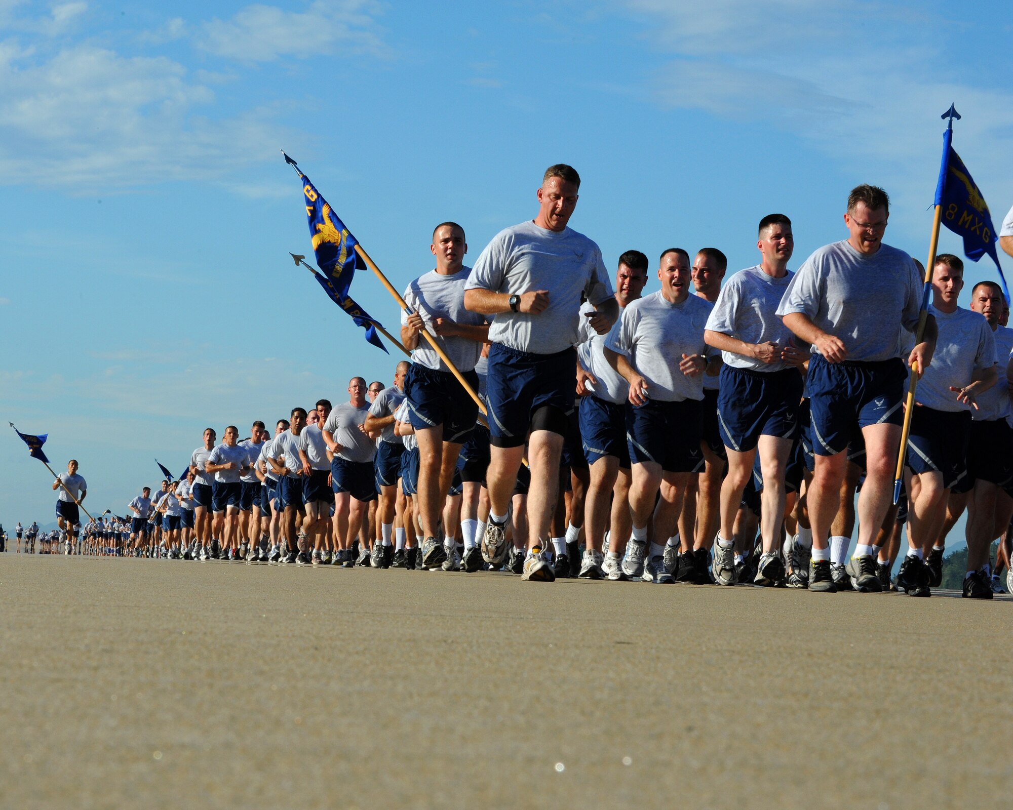 Members of the 8th Fighter Wing run along the flight line during a Warrior Run on Kunsan Air Base, Republic of Korea, Aug. 3, 2012. The run was approximately two and a half miles and included a majority of the base squadrons. (U.S. Air Force photo/Staff Sgt. Jonathan Fowler)