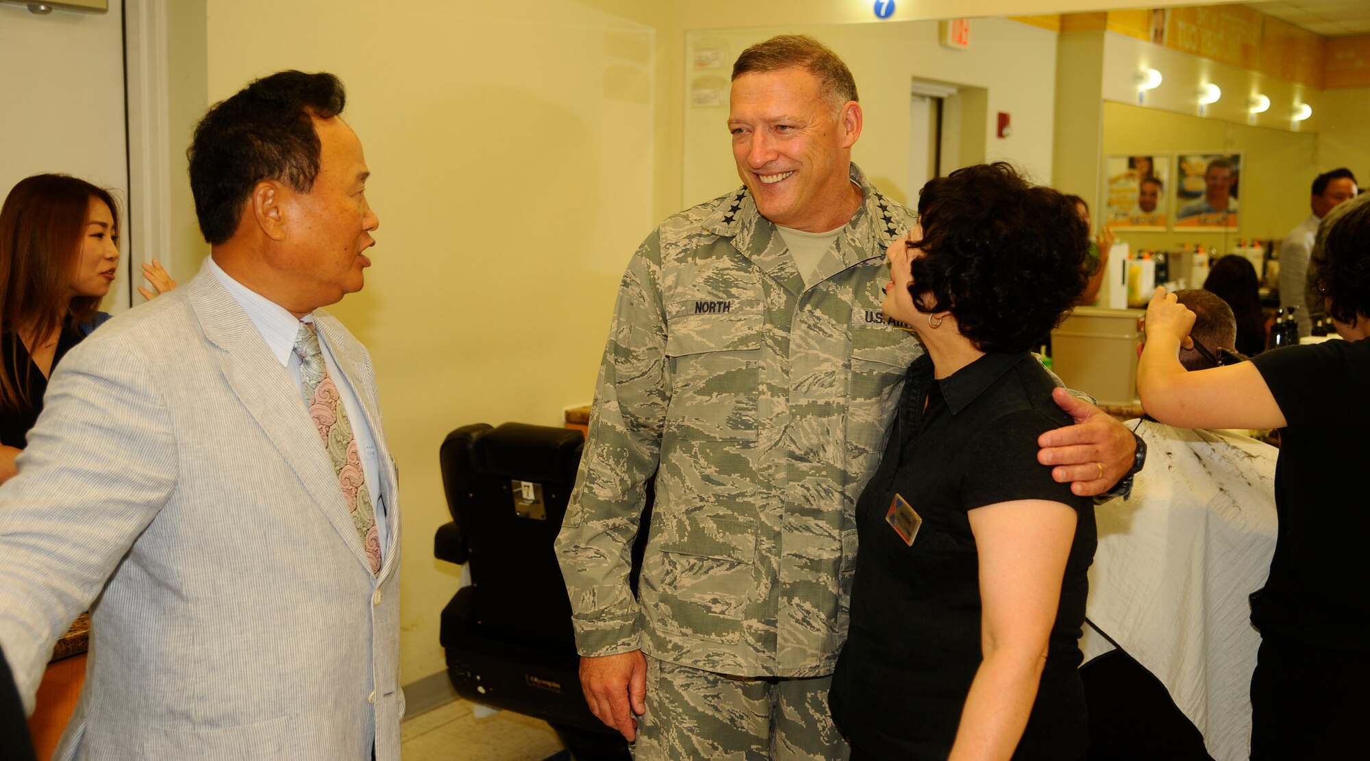 Gen. Gary North, Pacific Air Forces commander, visits the Base Exchange Barber Shop at Kunsan Air Base, Republic of Korea, July 18, 2012. North used some of his time while he was at Kunsan to visit friends Yun Nae Pak, left, owner, Base Exchange Barber Shop, and Sun Kyoung Yi, right, stylist, Base Exchange Barber Shop. (U.S. Air Force photo/Senior Airman Marcus Morris)