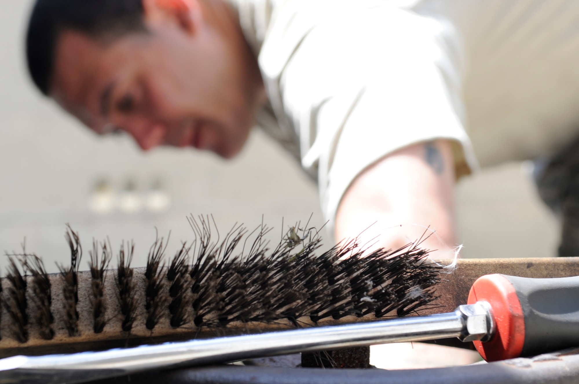 heating, ventilation and air conditioning technician from the 8th Civil Engineer Squadron removes bolts from a water pipe while installing a new AC unit for a dormitory at Kunsan Air Base, Republic of Korea, July 30, 2012. The daylong project required three shops from the squadron to coordinate to provide air conditioning for the 100 Airmen who live in the dorm. (U.S. Air Force photo/Senior Airman Brigitte N. Brantley)