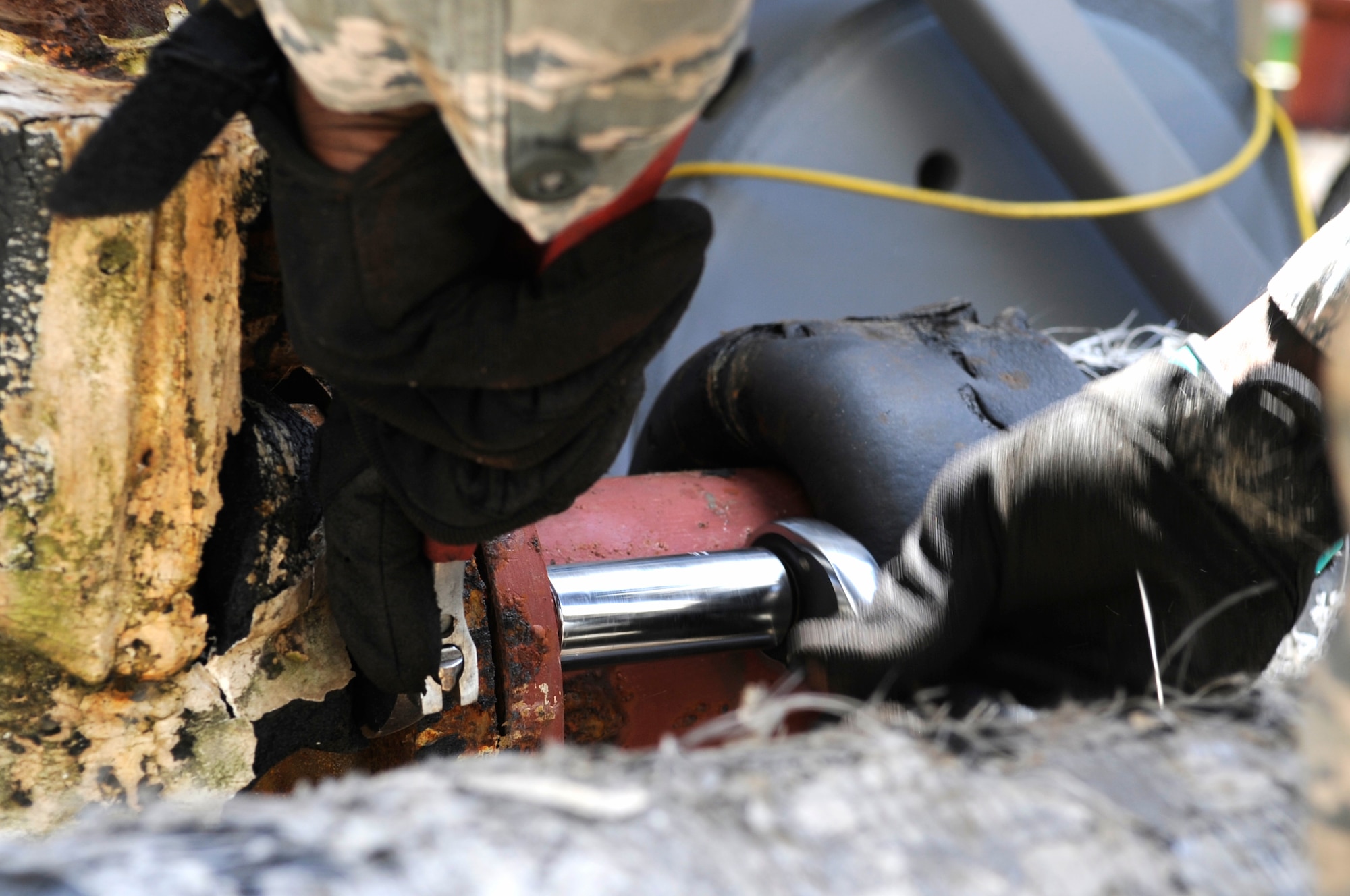 heating, ventilation and air conditioning technician from the 8th Civil Engineer Squadron removes bolts from a water pipe while installing a new AC unit for a dormitory at Kunsan Air Base, Republic of Korea, July 30, 2012. The daylong project required coordination from three shops in the squadron to provide air conditioning for 100 Airmen. (U.S. Air Force photo/Senior Airman Brigitte N. Brantley)