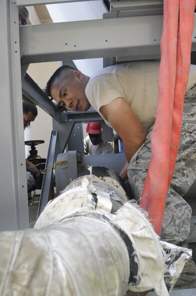 Tech. Sgt. Clement Cheung, 8th Civil Engineer Squadron heating, ventilation and air conditioning technician, lines up a pipe on a new AC unit at Kunsan Air Base, Republic of Korea, July 30, 2012. Replacing old chillers requires all water and power to be disconnected before removing the unit. (U.S. Air Force photo/Senior Airman Brigitte N. Brantley)