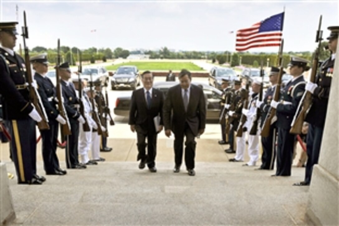 U.S. Defense Secretary Leon E. Panetta, right, escorts Japanese Defense Minister Satoshi Morimoto through an honor cordon into the Pentagon, Aug. 3, 2012. The two defense leaders met to discuss issues of mutual concern.