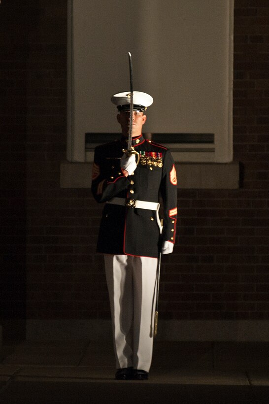 Staff Sgt. Manuel Saldivar, Company B first sergeant, salutes the parade adjutant during a special Friday Evening Parade at Marine Barracks Washington Aug. 3. Sgt. Maj. Micheal P. Barrett, sergeant major of the Marine Corps, served as the hosting official for this parade, which featured staff noncommissioned officers in positions traditionally held by officers.