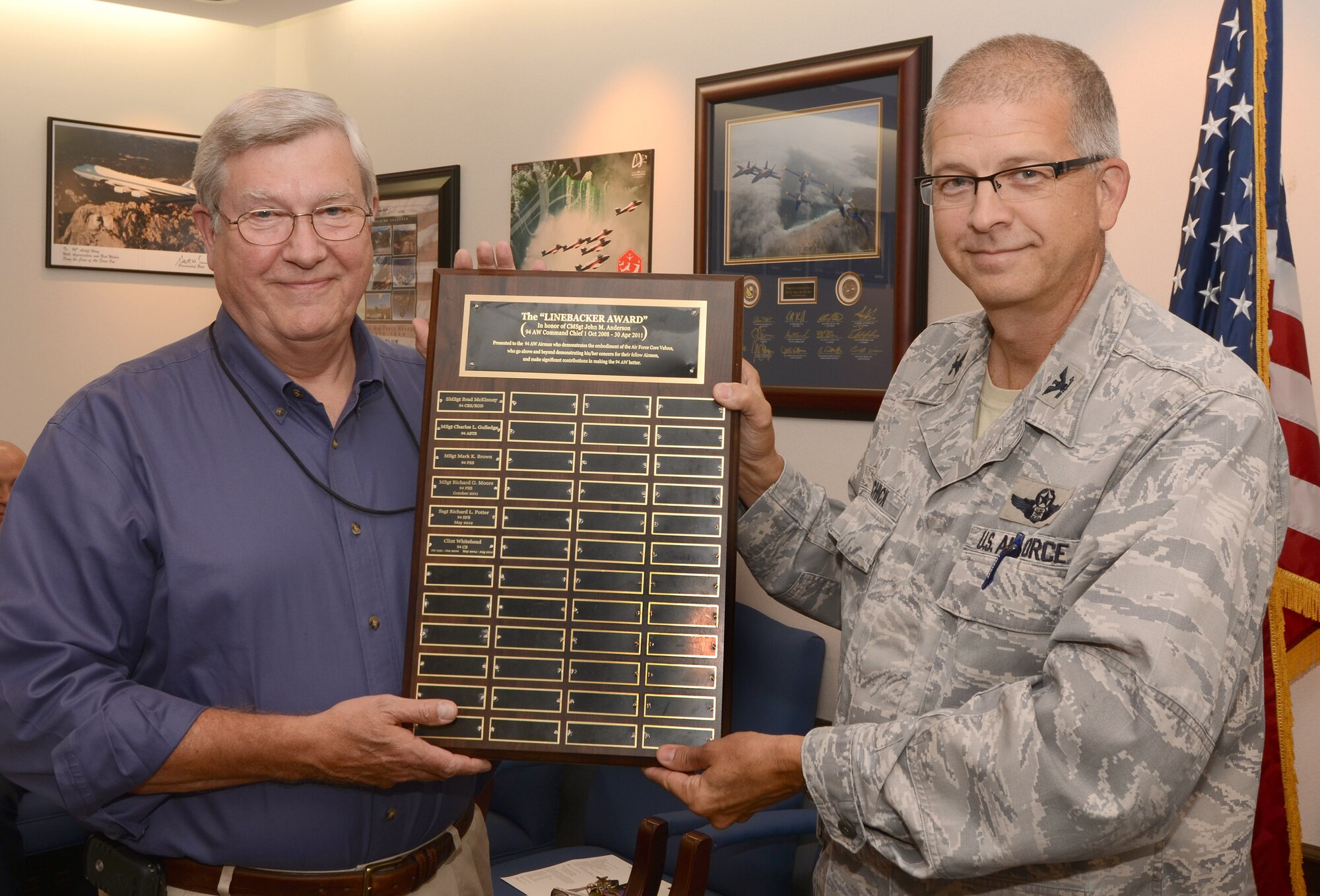Clinton Whitehead, of the 94th Airlift Wing Communications Squadron, receives the Chief Master Sgt. John M. Anderson Linebacker Award in honor of his 19 years of dedicated service providing information and communication support to Dobbins Air Reserve Base. Whitehead, a retired chief master sgt., has served Dobbins ARB as a contract manager and a civil servant. (U. S. Air Force photo/Brad Fallin)
