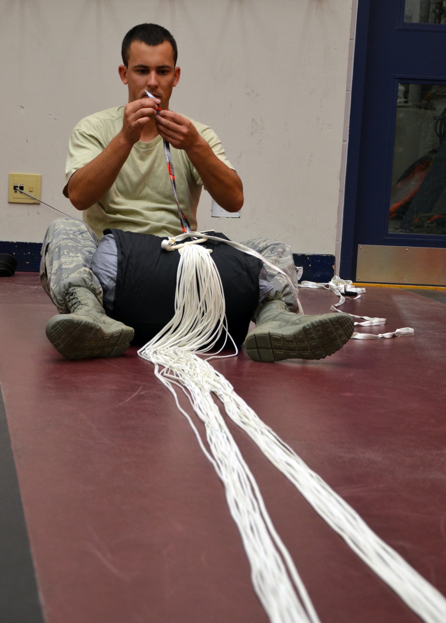 Tech. Sgt. Brian Pajor, a parachute rigger for the 920th Rescue Wing, Patrick Air Force, Base, Fla., carefully packs a pararescueman’s parachute for another jump July 19, 2012 in Comox, Canada. Airmen from the 920th Rescue Wing, Air Force Reserve’s only search-and-rescue wing, trained with Canadian search-and-rescue personnel to learn from one another and build strong working relationships. (U.S. Air Force photo/Staff Sgt. Anna-Marie Wyant)