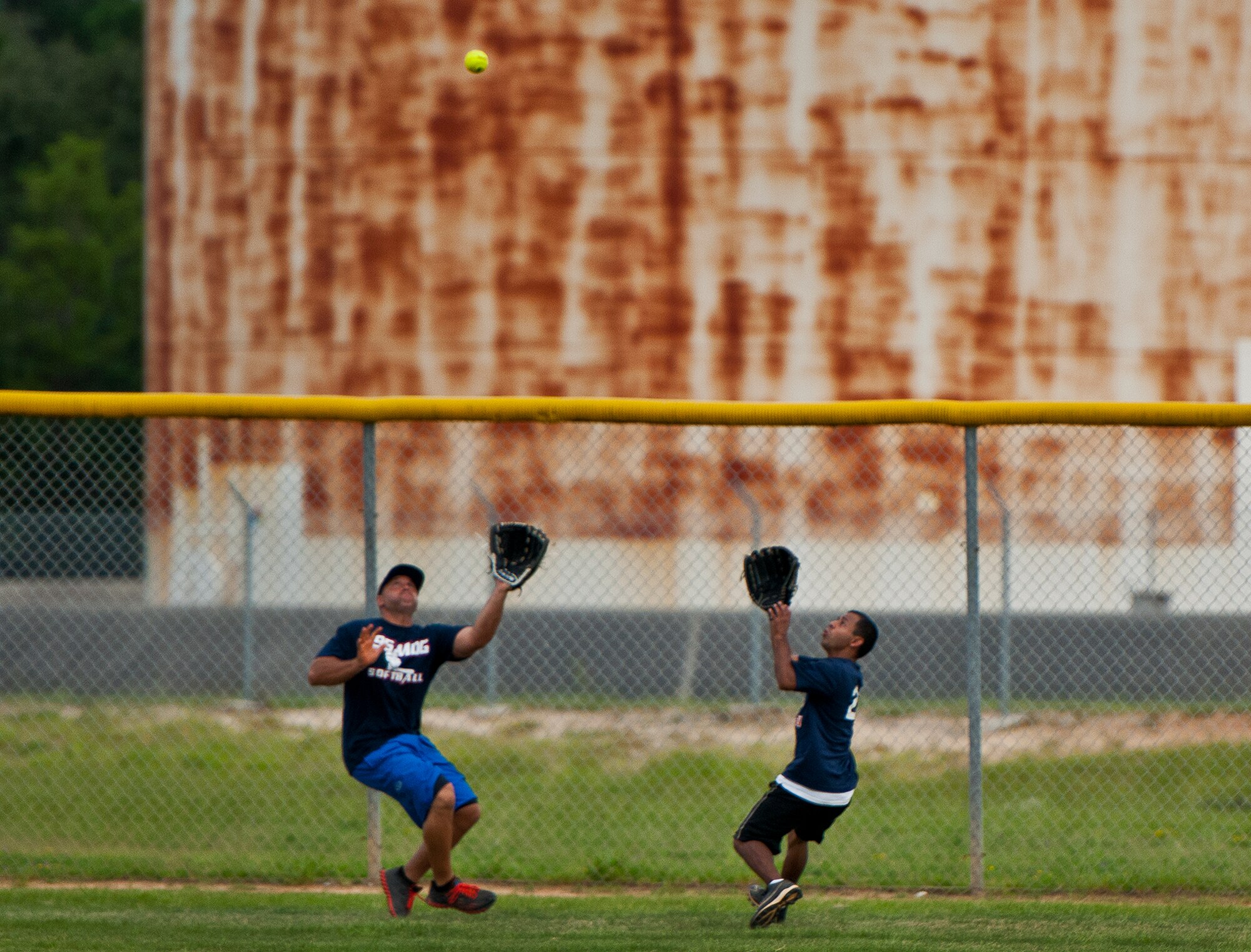 The 96th Medical Group’s Jeff Milam and Andrew Salas go for a fly ball in the outfield during the intramural softball championship game Aug. 2 at Eglin Air Force Base, Fla.  MDG won the championship beating the Armament Directorate in final inning 7-6.  (U.S. Air Force photo/Samuel King Jr.)
