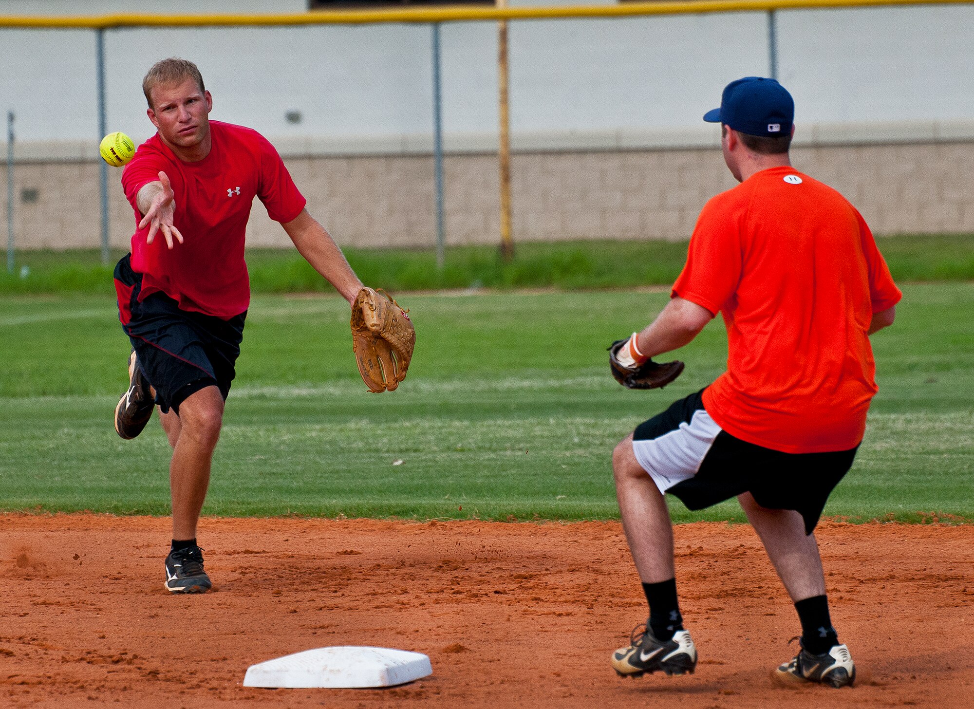 Jimmy Herold tosses the ball to Corey Skipper to try to turn a double play for the Armament Directorate during the intramural softball championship game Aug. 2 at Eglin Air Force Base, Fla.  MDG won the championship beating the Armament Directorate in final inning 7-6.  (U.S. Air Force photo/Samuel King Jr.)