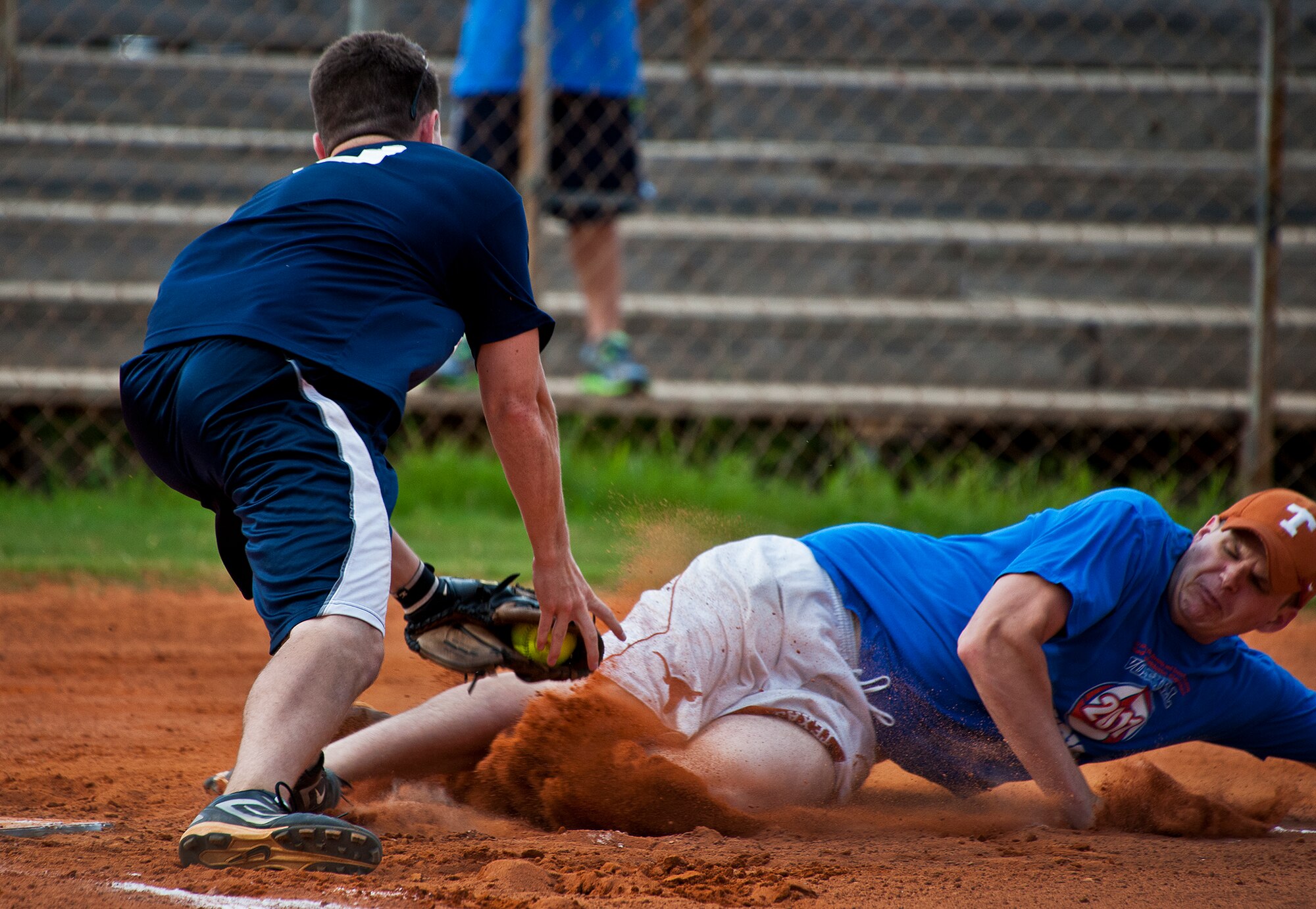 Tate Maples, of the 96th Medical Group, makes the tags out Rob Lefevers, of the Armament Directorate, at home plate to save a run during the intramural softball championship game Aug. 2 at Eglin Air Force Base, Fla.  MDG won the championship beating the Armament Directorate in final inning 7-6.  (U.S. Air Force photo/Samuel King Jr.)