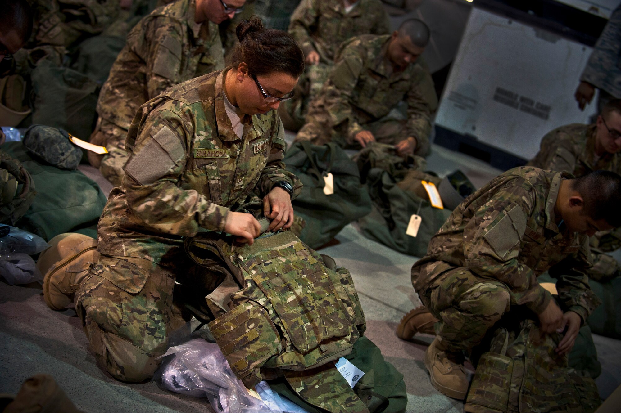 Airman 1st Class Natalia Barahona assembles her tactical vest vest during equipment distribution at the Transit Center at Manas, Kyrgyzstan, August 4, 2012. The Transit Center's Expeditionary Theater Distribution Center team can support up to 500 transient personnel a day. Barahona is a air transportation journeyman deployed out of Joint Base Pearl Harbor-Hickam and is a native of San Francisco. (U.S. Air Force photo/Senior Airman Brett Clashman)