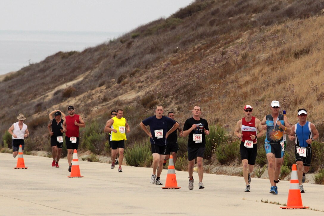 Participants competing in the Sprint Triathlon hosted by Marine Corps Community Services Semper Fit Hard Corps Race Series run the final stretch of the three-mile run on Camp Pendleton, Aug. 4. About 1200 competitors, military and civilian, participated in the triathlon.