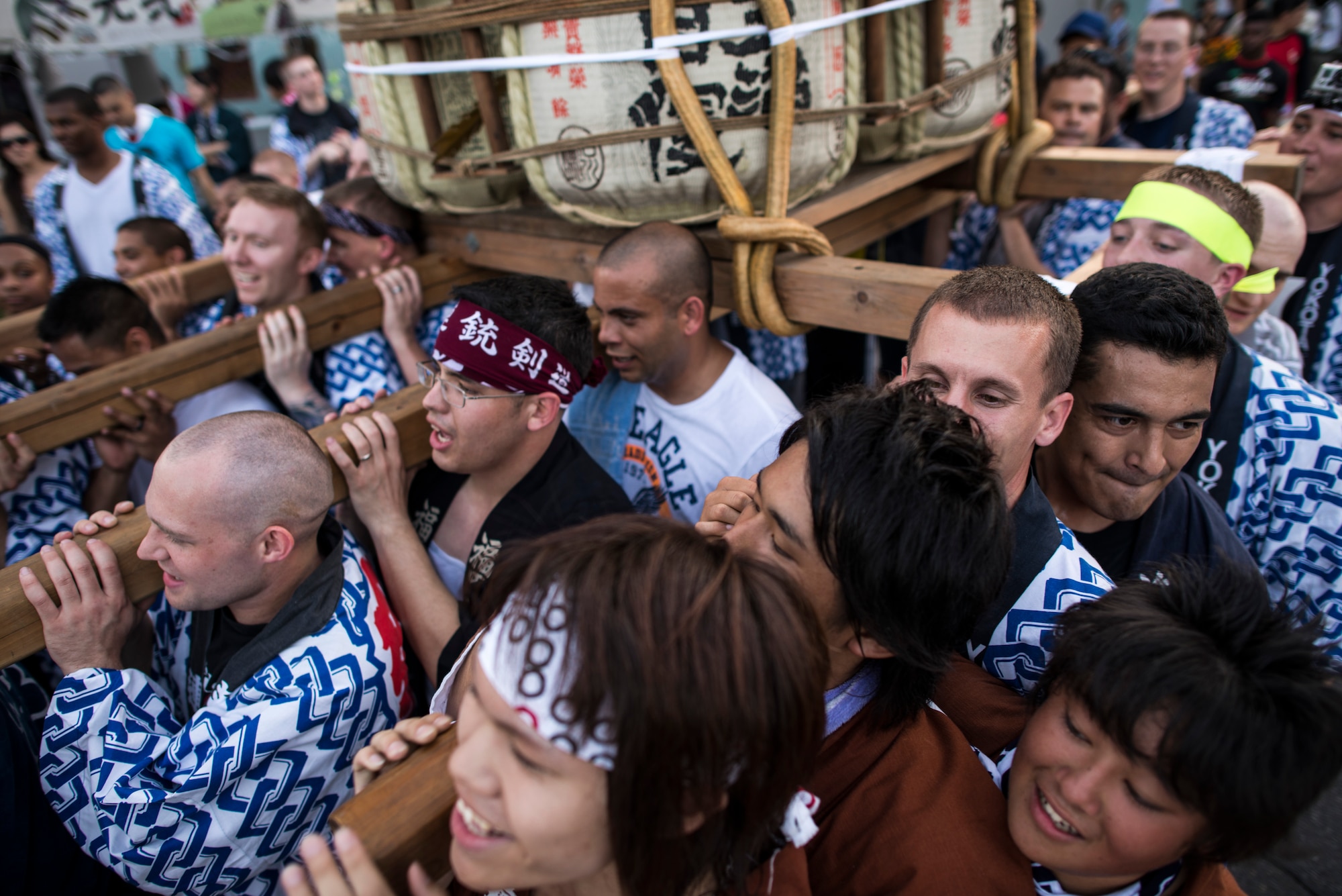 FUSSA CITY, Japan -- Volunteers from Yokota Air Base carry a mikoshi shrine through downtown Fussa City, Japan, during the 62nd annual Fussa Tanabata Festival Aug. 3, 2012. Approximately 80 service members from Yokota helped carry the shrine through the half-mile parade route. (U.S. Air Force photo by Tech. Sgt. Samuel Morse)