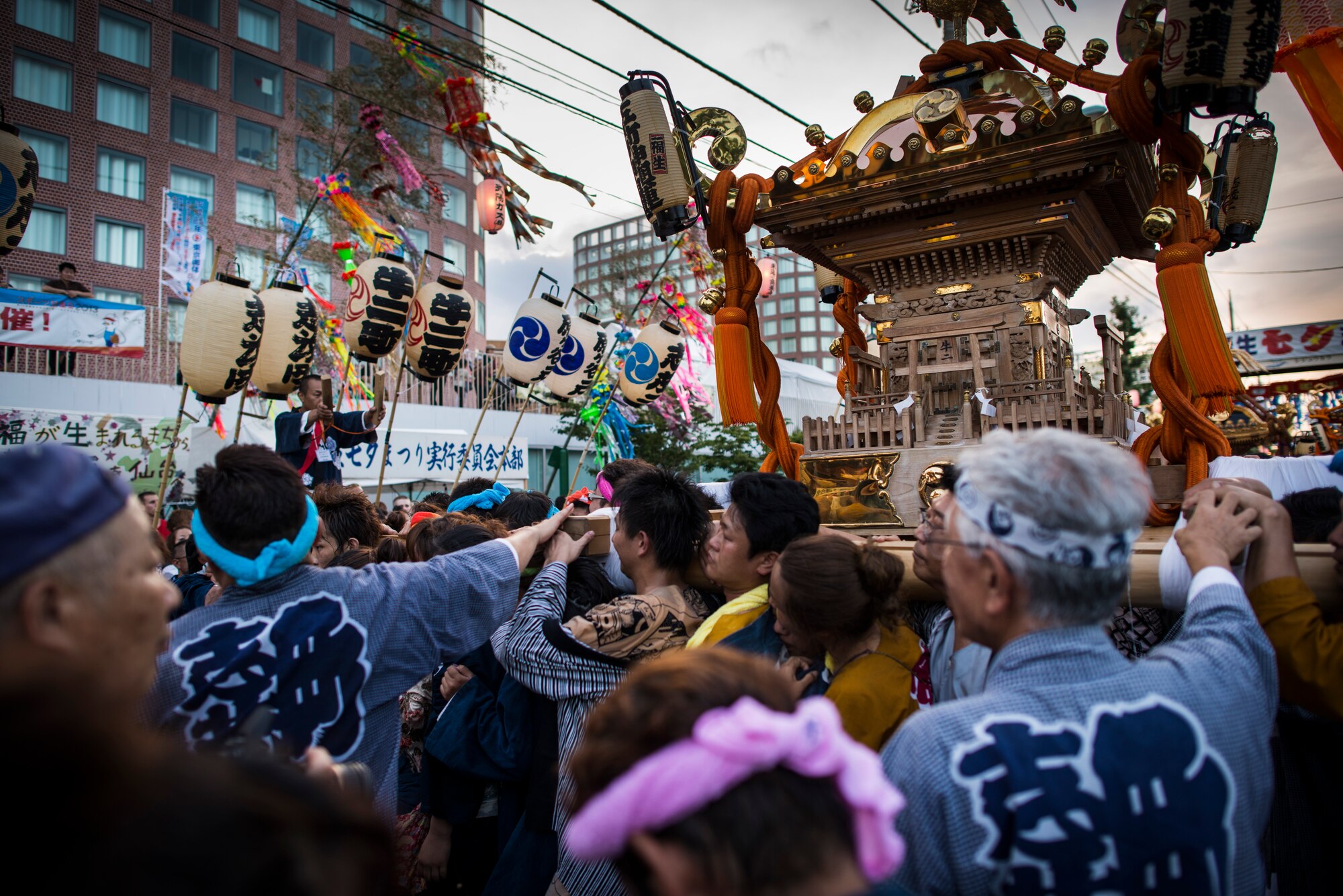 FUSSA CITY, Japan -- Mikoshi shrine carriers hoist their shrine in front of Fussa City Hall, Fussa City, Japan, on Aug. 3, 2012. Multiple shrines were carried from a nearby Shinto shrine to City Hall during the 62nd annual Fussa Tanabata Festival. (U.S. Air Force photo by Tech. Sgt. Samuel Morse)