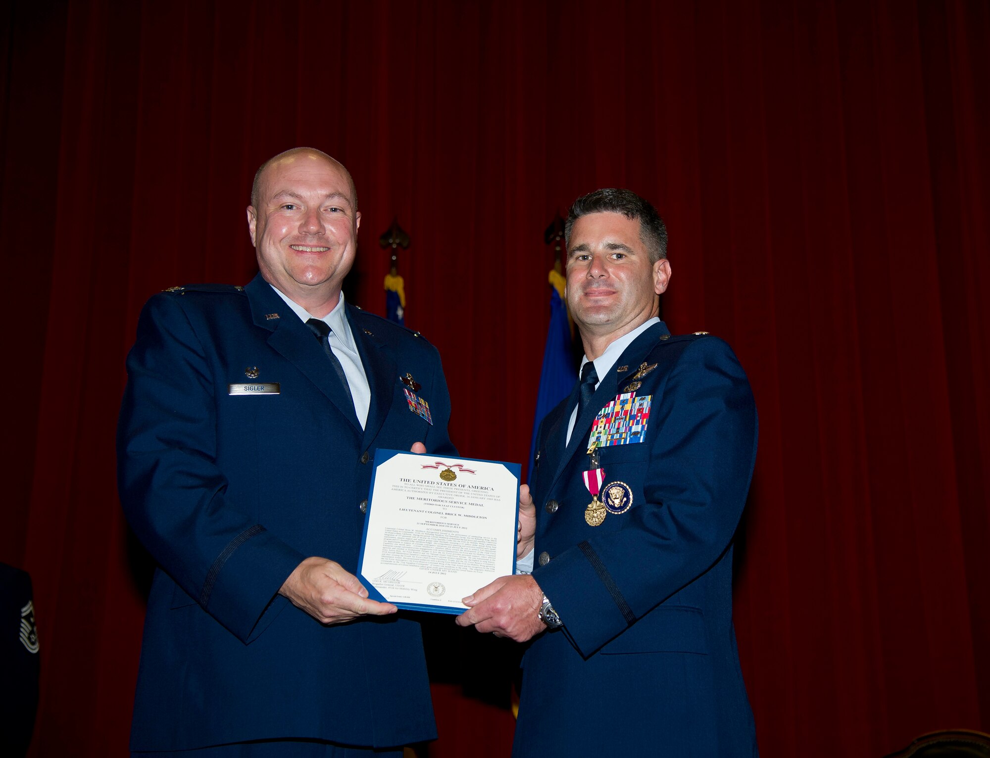 Lt. Col. Scott Minton, 912th Air Refueling Squadron incoming commander, takes command of the 912th ARS from Lt. Col. Brice Middleton, 912th ARS outgoing commander, July 21, during a change of command ceremony in the Cultural Resource Center. Col. Shawn Teagan, 92nd Operations Group commander, Fairchild AFB, Wash., presided over the event. Senior Master Sgt. Eric Butt, 912th ARS first sergeant, holds the guidon which symbolizes the transfer of authority from the old to the new commander. (U.S. Air Force photo by Staff Sgt. Matthew Smith) 