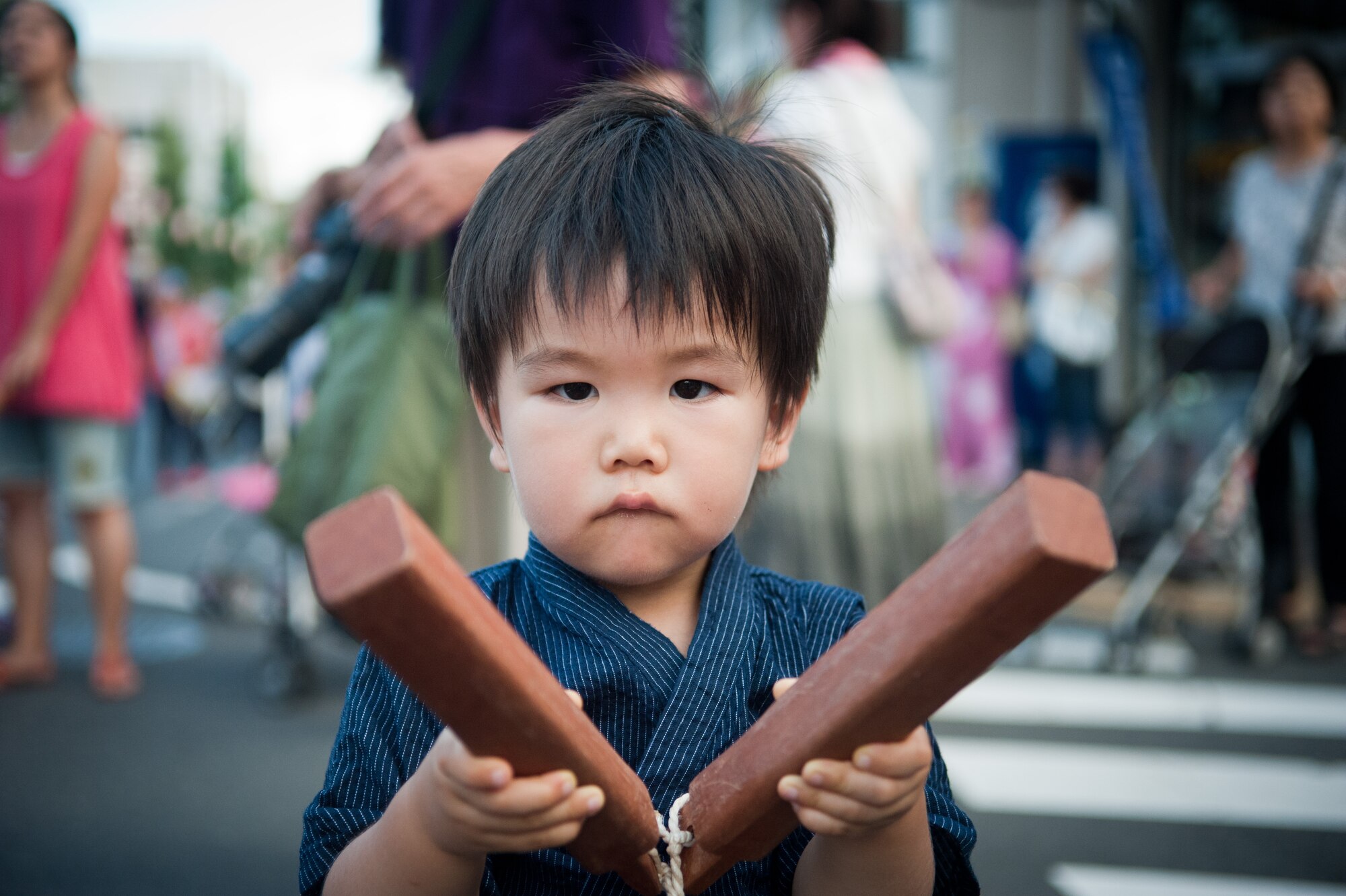 FUSSA CITY, Japan -- A Japanese child uses a hyoshigi, a wooden clapper, during the Tanabata Festival in Fussa City, Japan, on Aug. 3, 2012. This year marked the 62nd annual Tanabata Festival in Fussa, and it attracts people from all over the surrounding area. (U.S. Air Force photo by Airman 1st Class John D. Partlow)