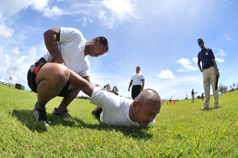 ANDERSEN AIR FORCE BASE, Guam-Department of Defense police officer cadets train with Oleoresin Capsicum Spray through a five-station obstacle course for qualification here July 27. After completing the course, the recruits will become DoD police officers for Andersen AFB and security guards for Naval Base Guam. This training is required so officers get first-hand experience using the weapon and can still perform their duties if they are sprayed during an incident. The academy is nine weeks for DoD police officer’s and five weeks for the security guards. The current class consists of 18 police officers and two security guards. Upon completion, 17 DoD police officers will be assigned to Andersen. This program was postured to enhance the security of the installation and ensure qualified personnel are manning the gates and patrols. (U.S. Air Force Photo by Staff Sgt. Alexandre Montes/RELEASED) 
