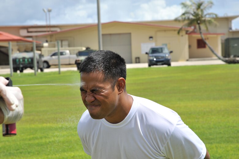 ANDERSEN AIR FORCE BASE, Guam-Department of Defense police officer cadets train with Oleoresin Capsicum Spray through a five-station obstacle course for qualification here July 27. After completing the course, the recruits will become DoD police officers for Andersen AFB and security guards for Naval Base Guam. This training is required so officers get first-hand experience using the weapon and can still perform their duties if they are sprayed during an incident. The academy is nine weeks for DoD police officer’s and five weeks for the security guards. The current class consists of 18 police officers and two security guards. Upon completion, 17 DoD police officers will be assigned to Andersen. This program was postured to enhance the security of the installation and ensure qualified personnel are manning the gates and patrols. (U.S. Air Force Photo by Staff Sgt. Alexandre Montes/RELEASED) 