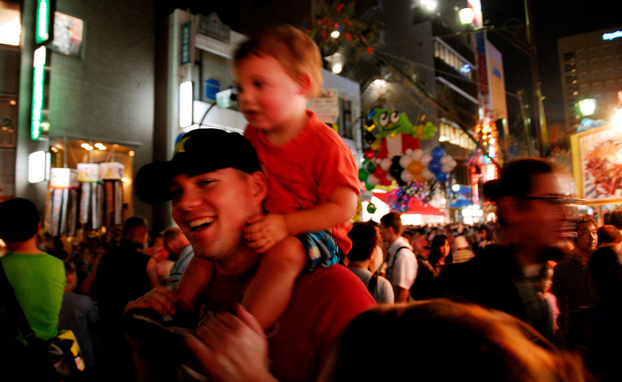 FUSSA CITY, Japan – David Goodman enjoys the 62nd annual Tanabata Festival in Fussa City, Japan, with his son, Adam, August 3, 2012. Tanabata is the Japanese star festival originating from the Chinese Qixi Festival, celebrating the meeting of the stars Vega and Altair. (U.S. Air Force photo by Senior Airman Lynsie Nichols)