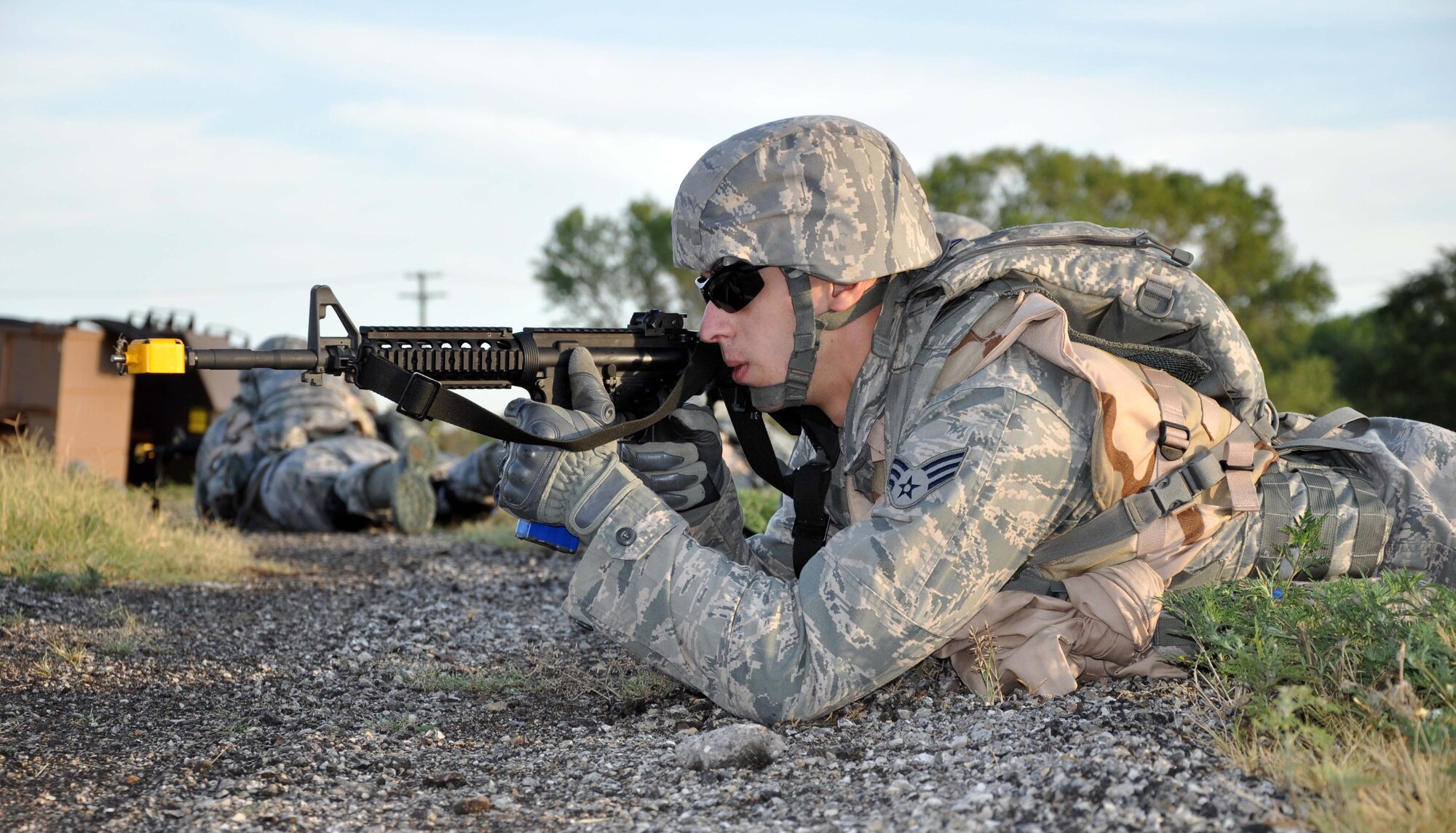 Senior Airman Michael Duvall, 931st Security Forces Squadron, returns fire at attackers during a field training exercise at McConnell Air Force Base, Kan., August 5, 2012. The 931 SFS conducted a four-day field training exercise to help prepare the squadron for future deployments.  (U.S. Air Force photo by 1st Lt. Zach Anderson)