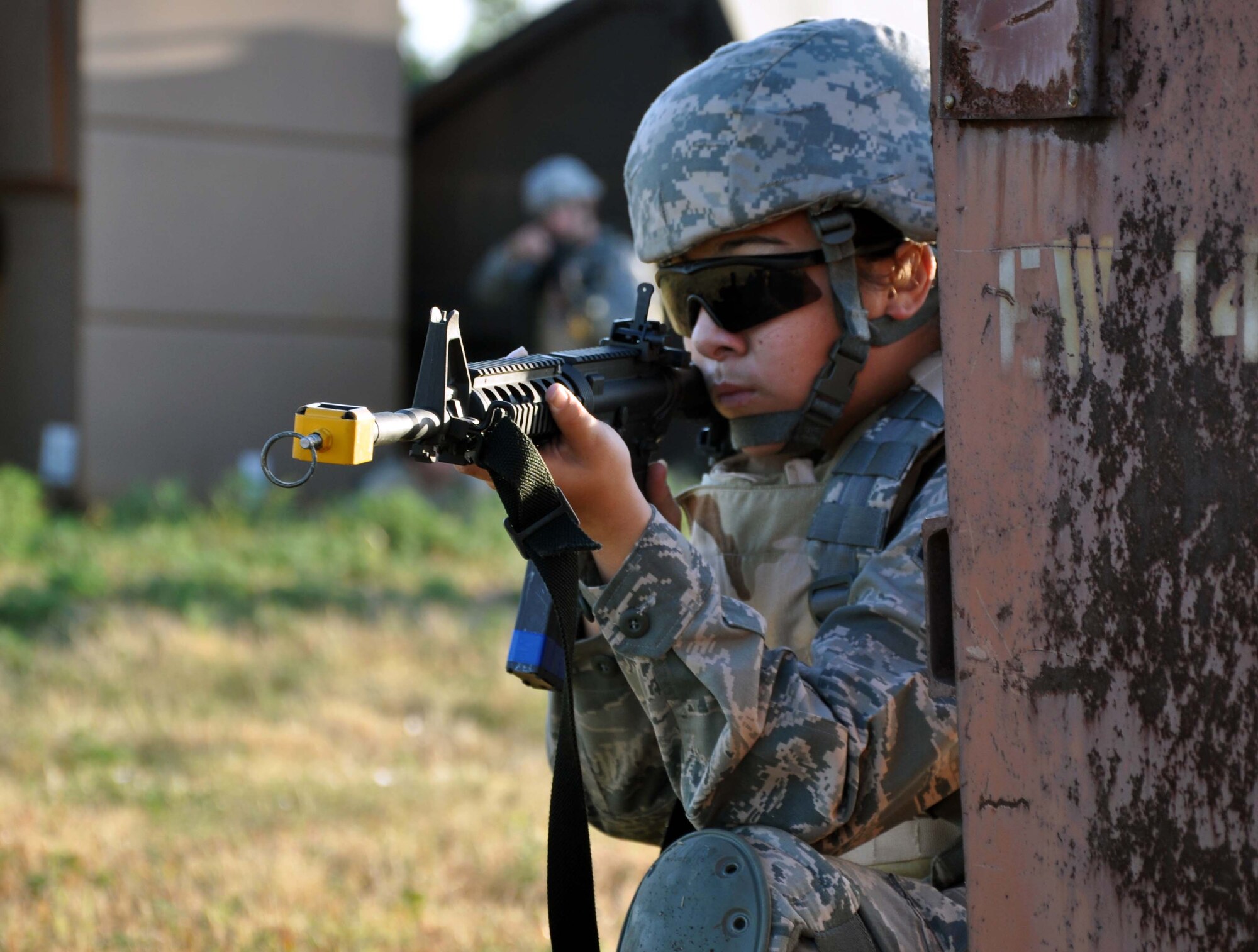 Airman Skylar Kamer, 931st Security Forces Squadron, prepares to return fire during a field training exercise at McConnell Air Force Base, Kan., August 5, 2012. The 931 SFS conducted a four-day field training exercise to help prepare the squadron for future deployments.  (U.S. Air Force photo by 1st Lt. Zach Anderson)