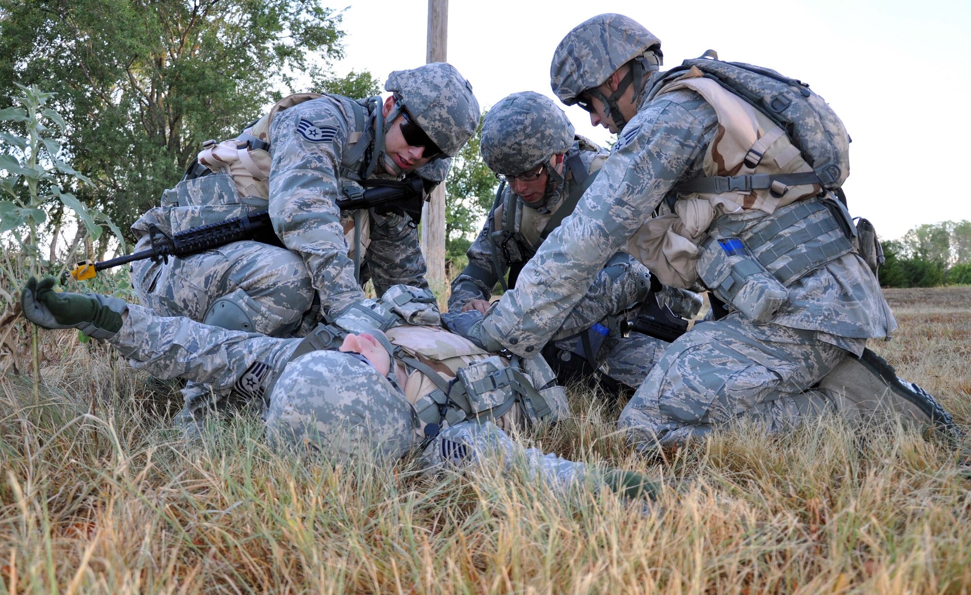 Members of the 931st Security Forces Squadron respond to a training scenario involving a wounded Airman as part of a field training exercise conducted at McConnell Air Force Base, Kan., August 5, 2012.  The 931 SFS conducted a four-day field training exercise to help prepare the squadron for future deployments.  (U.S. Air Force photo by 1st Lt. Zach Anderson)