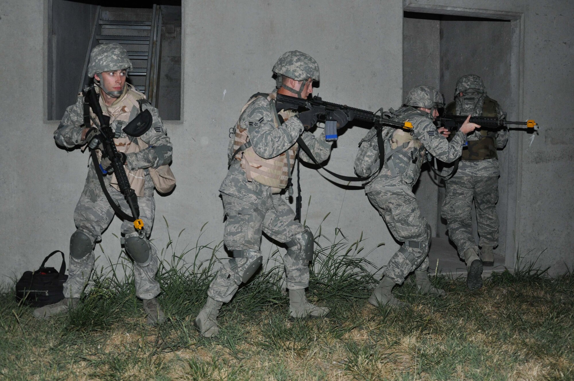 Airmen of the 931st Security Forces Squadron conduct training on entering and clearing buildings during night operations as part of a field training exercise at the Military Operations and Urban Training facility at McConnell Air Force Base, Kan., Aug. 3, 2012. The four-day exercise was conducted to help prepare the 931 SFS for future deployments. (U.S. Air Force photo by 1st Lt. Zach Anderson) 