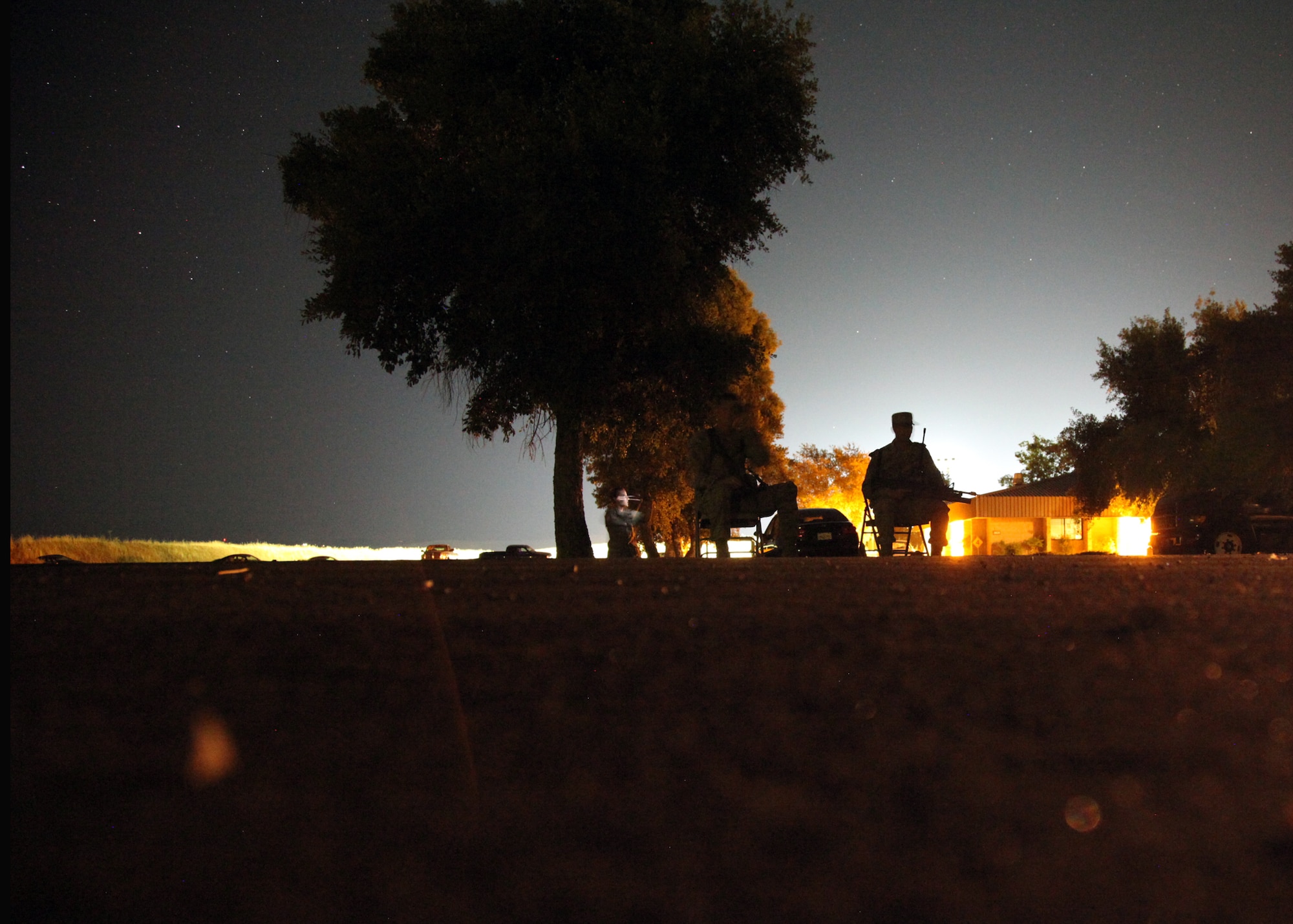 A 940th Security Forces Squadron member keeps watch from a defensive fighting position along the perimeter of the unit’s training encampment as the sun sets on another day. The Reserve unit held its first annual Field Training Exercise during a three-day Unit Training Assembly, July 6-8, 2012, at Beale Air Force Base, Calif. (U.S. Air Force photo/Tech. Sgt. Kenneth McCann)