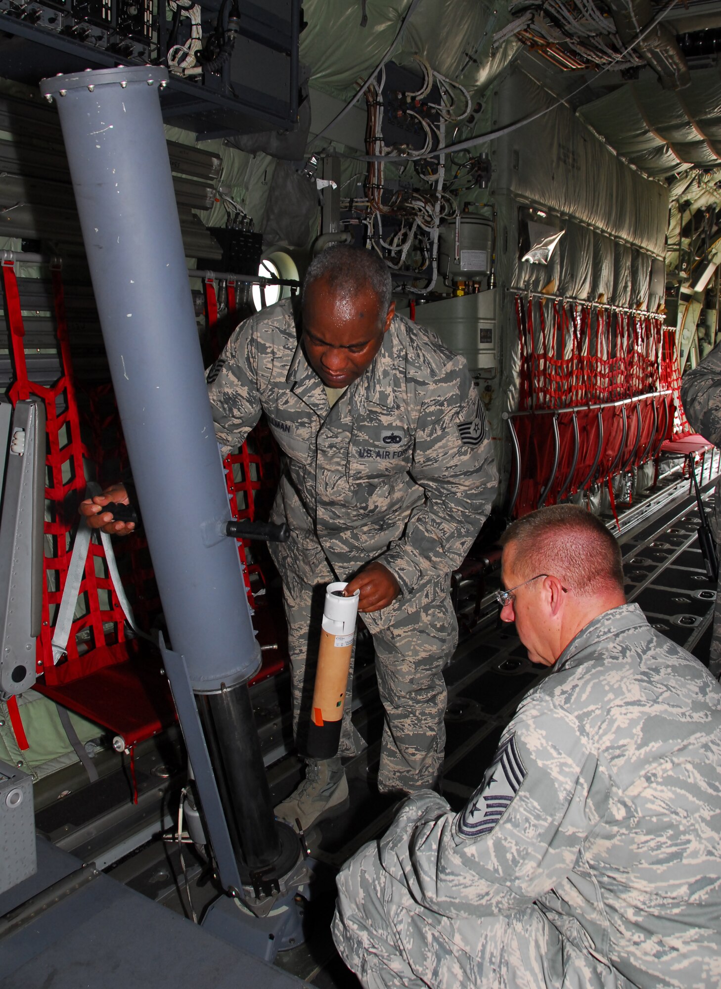 Tech Sgt. Matt Tillman, 403rd AMXS Meterological Shop Specialty, demonstrated a dropsonde used by the Hurricane Hunters to 22nd Air Force Command Chief Master Sgt. Steven Larwood, who visited the 403rd Wing during the August UTA.  (U.S. Air Force Photo Tech Sgt. Jessica Kendziorek)