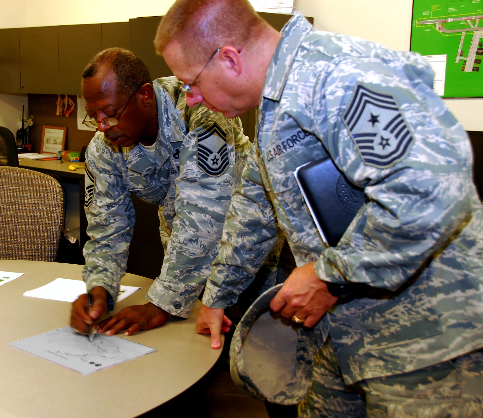 Senior Master Sgt. Charles Moore, 403 Aircraft Maintenance Squadron, Production Superintendent of WC130 Aircraft, explains the Hurricane Hunter's forward deployment strategy to 22nd Air Force Command Chief Master Sgt. Steven Larwood, who visited the 403rd Wing during the August UTA.  (U.S. Air Force Photo Tech Sgt. Jessica Kendziorek)
