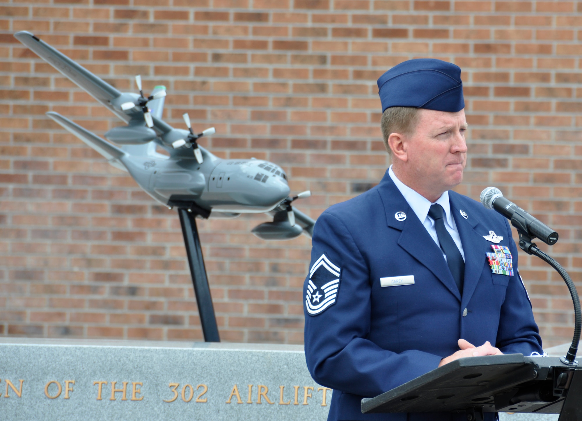 An emotional Senior Master Sgt. Dave Carey speaks fondly of his fellow Air Force Reservists who perished May 13, 1995, when their C-130 Hercules, call sign ‘Sumit 38,’ crashed approximately 60 miles southeast of Mountain Home, Idaho.  Carey, assigned to the 731st Airlift Squadron, narrated a re-dedication ceremony Aug. 4, 2012, at Peterson Air Force Base, Colo, honoring the six AF Reservists who perished during the crash. The memorial was re-dedicated with family members of the fallen and 302nd Airlift Wing and 52nd Airlift Squadron members present. It was moved from its previous location as part of the wing’s expansion under the Total Force Initiative framework. The Airmen who perished in the crash are: Lt. Col. Robert Buckhout; Capt. Geoffrey Boyd; 1st Lt. Lance Dougherty; Chief Master Sgt. Jimmie Vail; Master Sgt. Jay Kemp; and Staff Sgt. Michael Scheideman. (U.S. Air Force photo/Staff Sgt. Stephen J. Collier)