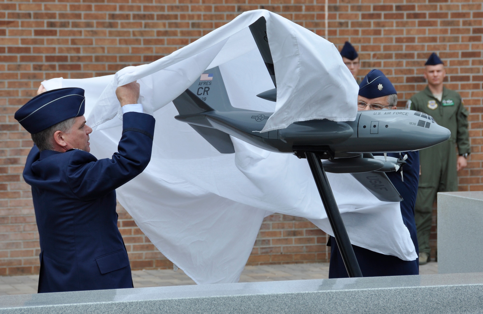 Air Force Reserve Col. Jay Pittman (left), 302nd Airlift Wing commander, together with Lt. Col. (ret.) Robert Stout, unveils to the public the ‘Sumit 38’ memorial during a re-dedication ceremony Aug. 4, 2012, at Peterson Air Force Base, Colo.  Pittman, together with Stout, ushered in the re-dedication of the memorial which honors the six AF Reservists who perished during the crash of a C-130 Hercules on May 13, 1995. The memorial was re-dedicated with family members of the fallen and 302nd Airlift Wing and 52nd Airlift Squadron members present. The memorial was moved from its previous location as part of the wing’s expansion under the Total Force Initiative framework. The Airmen who were killed when their aircraft crashed approximately 60 miles southeast of Mountain Home, Idaho, are: Lt. Col. Robert Buckhout; Capt. Geoffrey Boyd; 1st Lt. Lance Dougherty; Chief Master Sgt. Jimmie Vail; Master Sgt. Jay Kemp; and Staff Sgt. Michael Scheideman.  (U.S. Air Force photo/Staff Sgt. Stephen J. Collier)