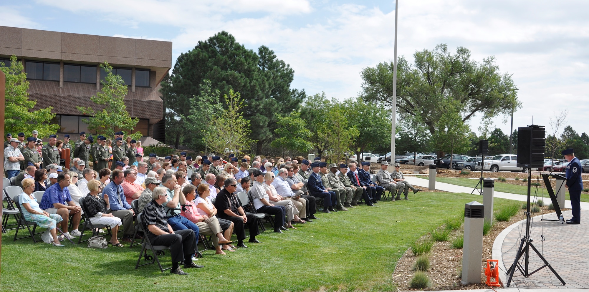 Family members and 302nd Airlift Wing Airmen listen as Air Force Reservist Senior Master Sgt. Dave Carey opens a re-dedication ceremony Aug. 4, 2012, at Peterson Air Force Base, Colo. The ceremony re-dedicated a memorial to ‘Sumit 38,’ an Air Force Reserve C-130 Hercules that crashed in May 1995 with six AF Reservists on board. The memorial was moved from its previous location as part of the wing’s expansion under the Total Force Initiative framework. The Airmen who perished when their aircraft crashed approximately 60 miles southeast of Mountain Home, Idaho, are: Lt. Col. Robert Buckhout; Capt. Geoffrey Boyd; 1st Lt. Lance Dougherty; Chief Master Sgt. Jimmie Vail; Master Sgt. Jay Kemp; and Staff Sgt. Michael Scheideman. (U.S. Air Force photo/Staff Sgt. Stephen J. Collier)