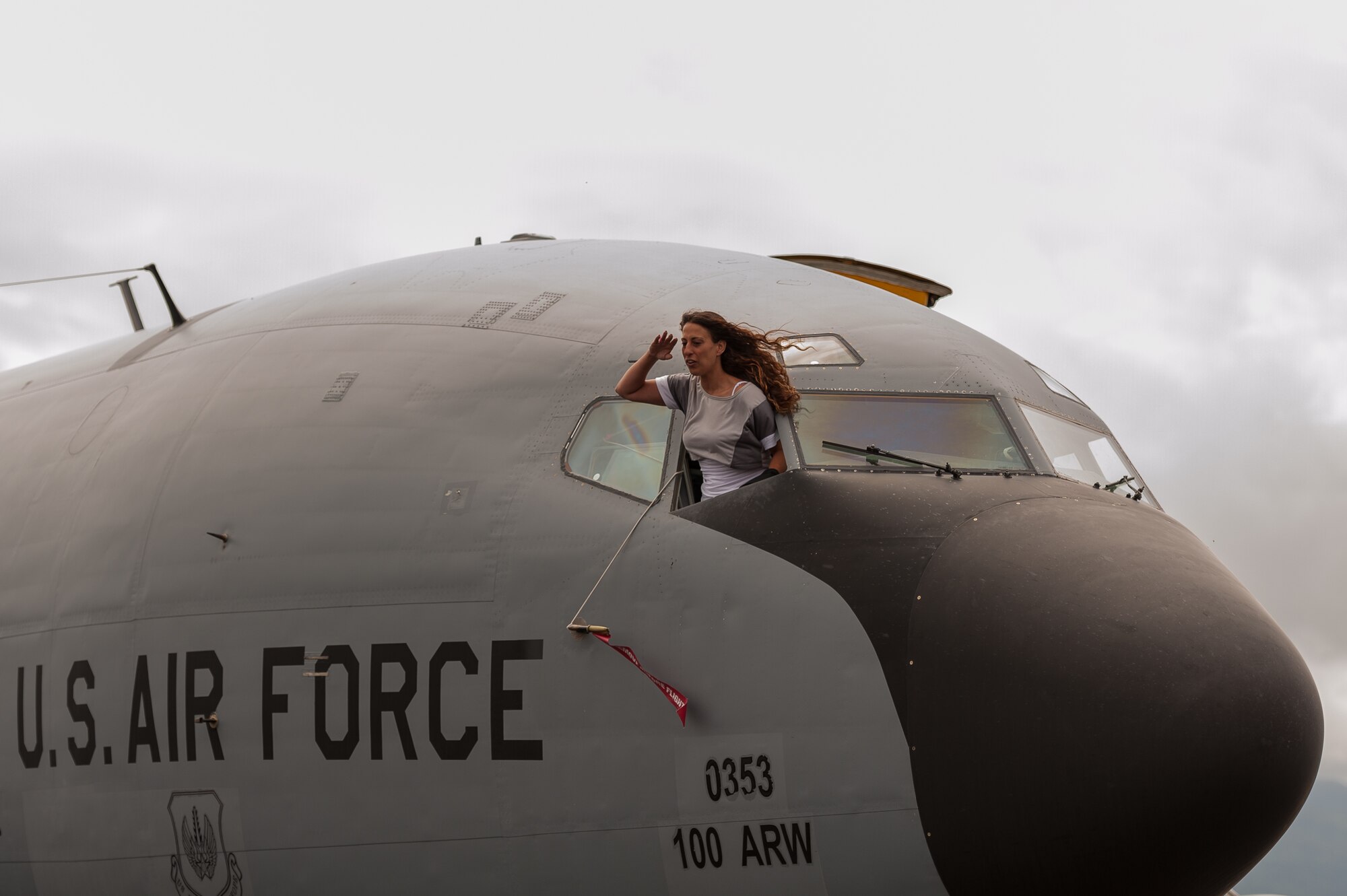 Sandy Viveiros, a local community member, salutes outside the window of a KC-135 Stratotanker during Open House at Lajes Field, Aug. 5, 2012.  Cooperation and solidarity with the Portuguese and U.S Air Forces enabled the base to open its gates during the Azores’ busiest time of the year; Praia Fest.  The Open House provided an opportunity for Team Lajes to showcase our military readiness and capabilities to our local community. (Photo by Lucas Silva)