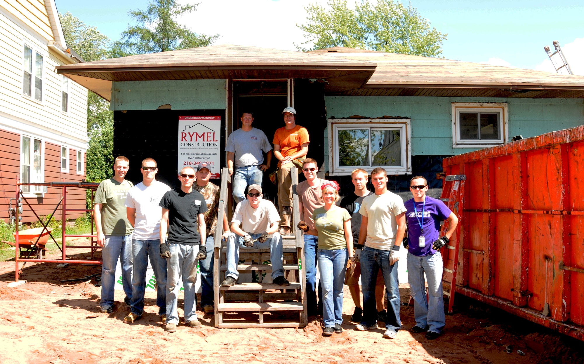 Members of the 148th Fighter Wing pose for a photo while volunteering to help Habitat for Humanity  remodel a house in Superior Wis., Saturday, Aug. 4, 2012.  Approximately 12 Bulldogs assisted with the construction, which ranged from extensive roof construction and new siding. (National Guard photo by Tech. Sgt. Scott G. Herrington