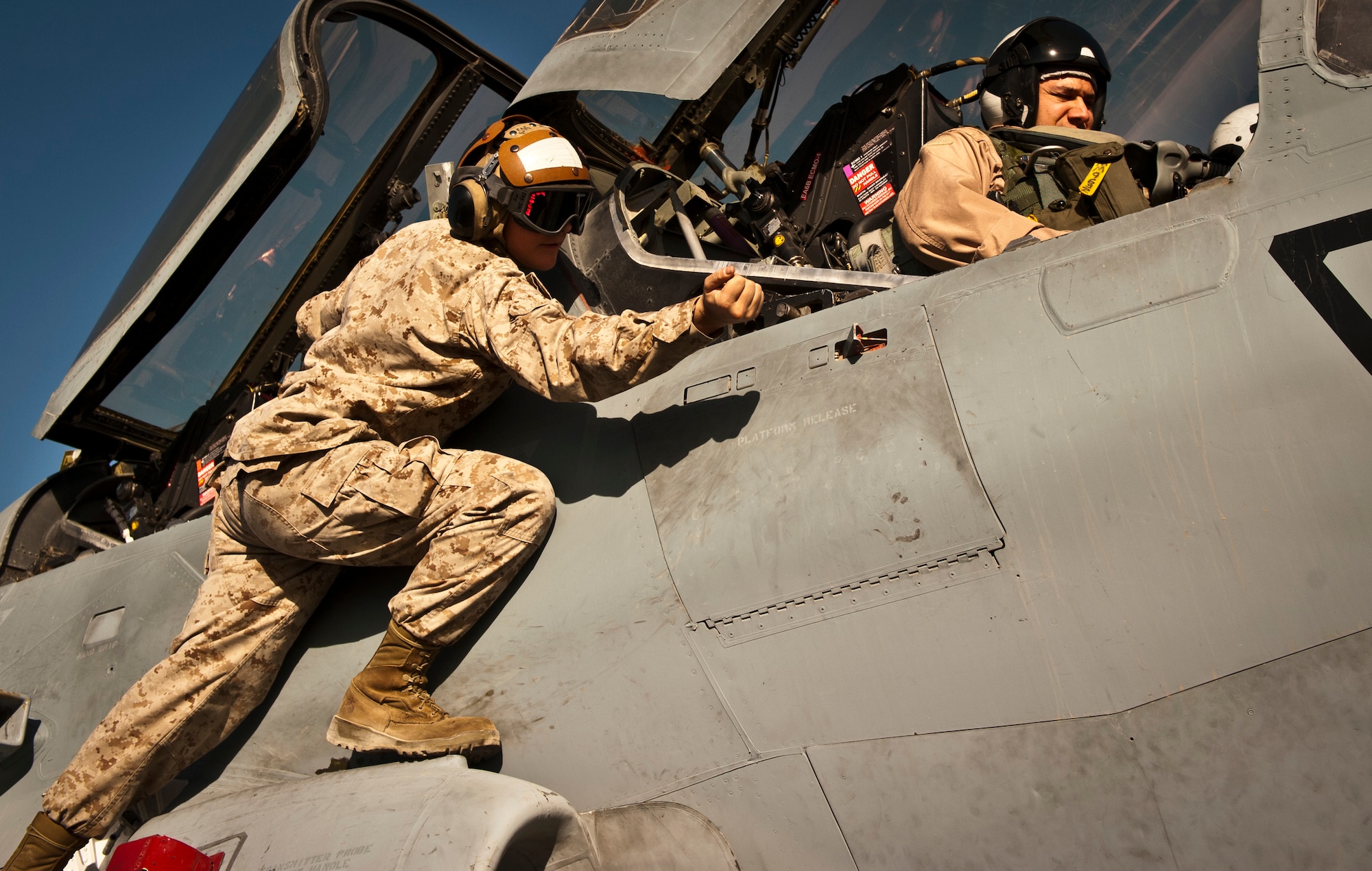 Corporal Shasta Little, a Plane Captain assigned to Marine Tactical Electronic Warfare Squadron-2, secures a panel latch on an EA-6B Prowler at Bagram Airfield, Afghanistan, 2 August, 2012. VMAQ-2 supports coalition forces in Afghanistan by interrupting enemy electronic activity in the combat area. (U.S. Air Force Photo/Capt. Raymond Geoffroy)