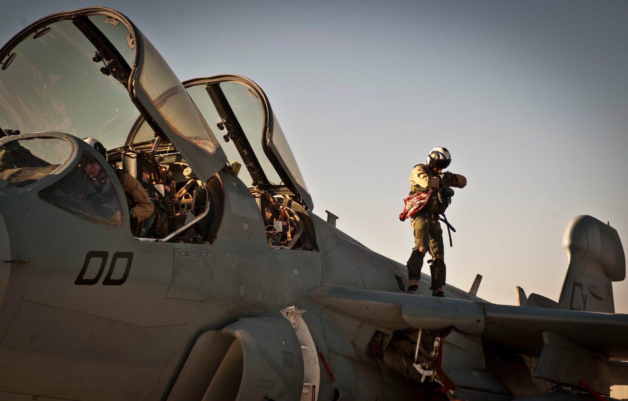 A U.S. Marine Corps aircrew assigned to Marine Tactical Electronic Warfare Squadron-2, perform pre-flight checks on an EA-6B Prowler at Bagram Airfield, Afghanistan, 2 August, 2012. In a fight where the enemy is updating their unconventional tactics, having a dedicated electronic warfare platform keeping watch over coalition forces can prove vital and the Marines of VMAQ-2 are well equipped to meet this mission. (U.S. Air Force Photo/Capt. Raymond Geoffroy)