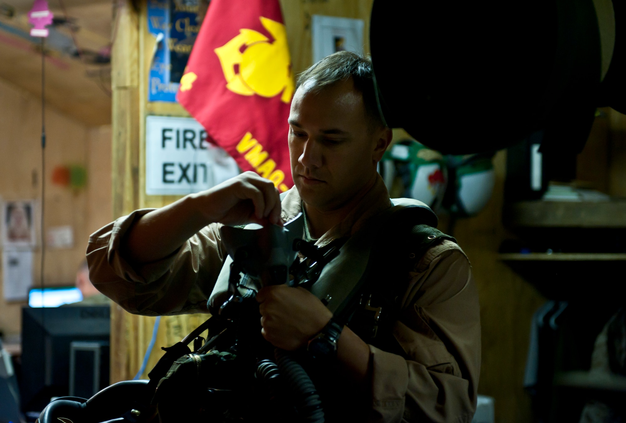 Marine Capt. Matt Mitchell, an Electronic Counter Measures Officer assigned to Marine Tactical Electronic Warfare Squadron-2, prepares his gear before a mission at Bagram Airfield, Afghanistan, 2 August, 2012. Mitchell supports coalition forces in Afghanistan by interrupting enemy electronic activity in the combat area. (U.S. Air Force Photo/Capt. Raymond Geoffroy)