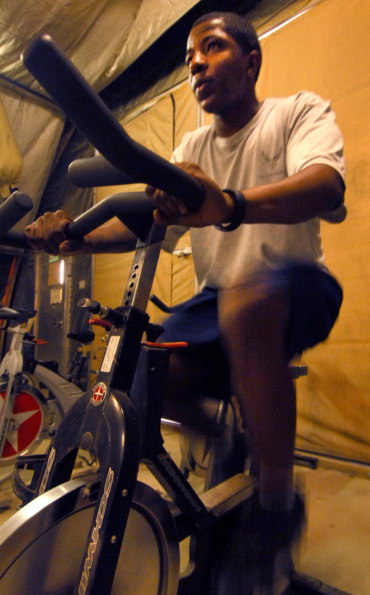 SrA Jamaar Meadows, 455th Expeditionary Communications Squadron cyber transport systems technician, works out on a stationary bike at the Pebble Gym at Bagram Airfield, Afghanistan, Aug. 2, 2012. Through dieting and exercise, he has lost 55 pounds in three months while deployed to BAF. Now that he has lost the weight, he wants to inspire others do the same. “If I can do it, anyone can,” said Meadows. (U.S. Air Force photo/SSgt Jeff Nevison)