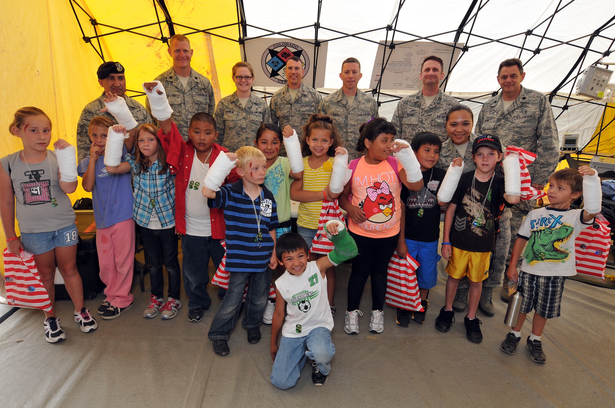 Members of the Colorado Air National Guard 140th Medical Group pose for a photo with kids that have been given fake wounds and temporary are cast during the health fair for the Southern Ute Tribal members, Ignacio, Colo., July 27, 2012.  The 140th Medical Group is in Southwest Colorado this week hosting a health fairs for the regions three Ute Tribes and the surrounding communities. (U.S. Air Force photo/Tech. Sgt. Wolfram M. Stumpf)