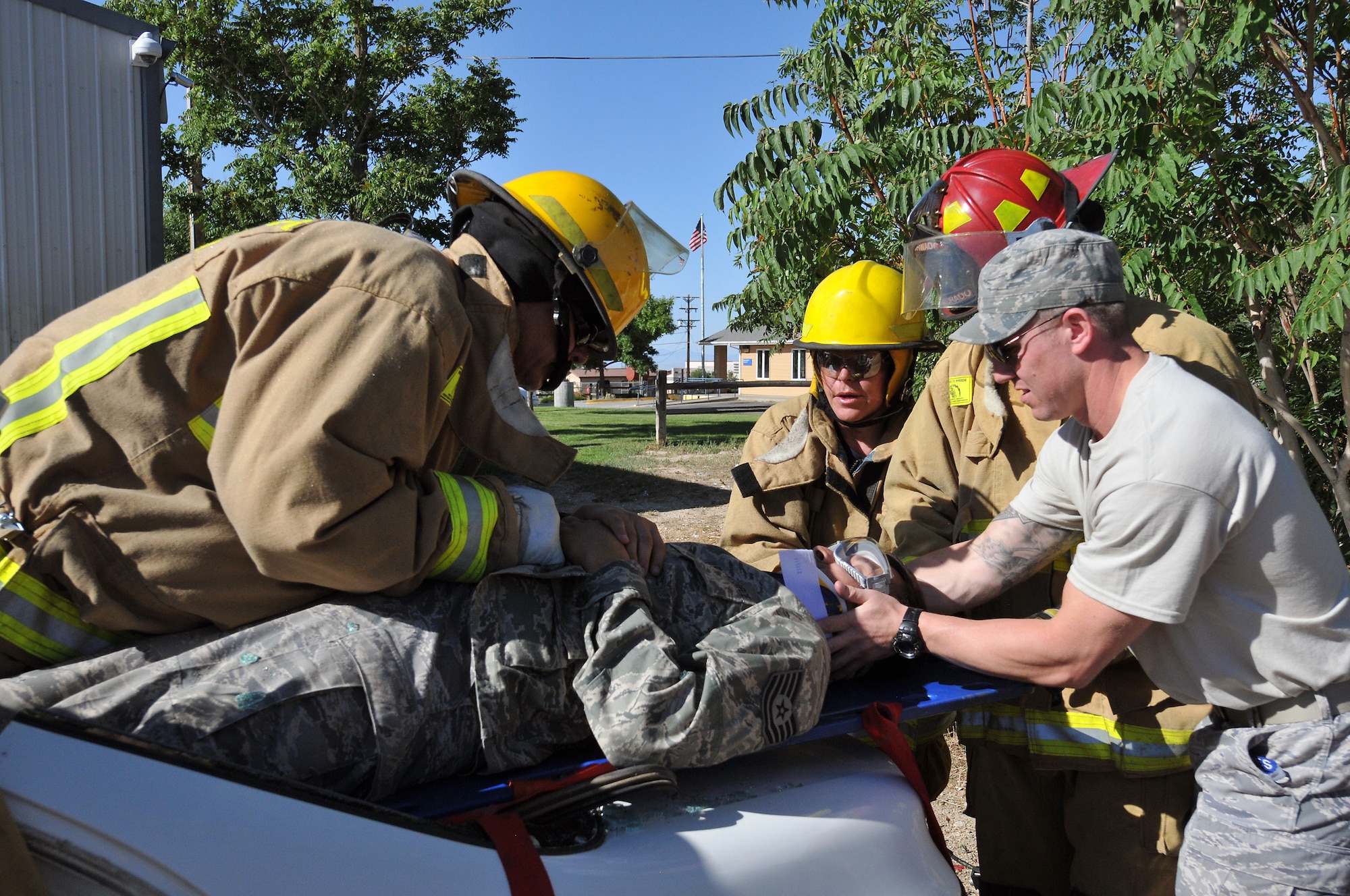 U.S. Air Force Tech. Sgt. Ricardo Coronado from the Colorado Air National Guard 140th Medical Group simulates being injured in an automobile accident while members of the Ute Mountain Fire and Rescue fire department and Tech. Sgt. Jeremy Jenkins practice how to safely remove victims from a vehicle after the top has been removed, Towaoc, Colo., July 26, 2012.  The 140th Medical Group is in Southwest Colorado this week hosting a health fair for the regions three Ute Tribes and the surrounding communities as well as leaning/sharing information with the local fire department that could help each other in a variety of emergency situations. (U.S. Air Force photo/Tech. Sgt. Wolfram M. Stumpf)