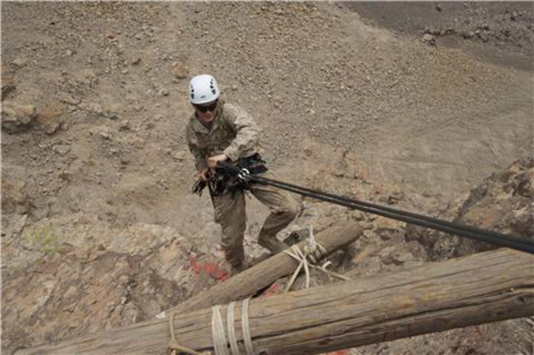 A U.S. Marine repels down the side of a cliff during an assault climbers course July 22. French and U.S. Marines participated in an assault climbing course in the rugged terrain of the Arta Range July 19 - 30. 