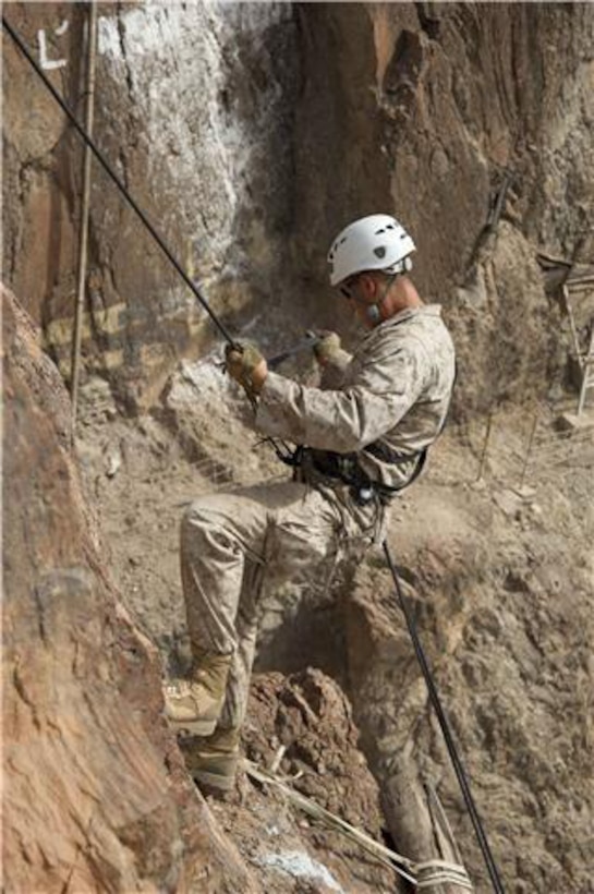 A U.S. Marine repels down the side of a cliff during an assault climbers course July 22. French and U.S. Marines participated in an assault climbing course in the rugged terrain of the Arta Range July 19 - 30. 