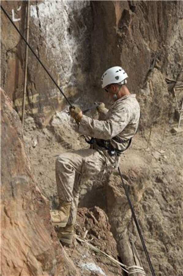 A U.S. Marine repels down the side of a cliff during an assault climbers course July 22. French and U.S. Marines participated in an assault climbing course in the rugged terrain of the Arta Range July 19 - 30. 
