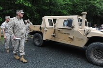 Commandant of the Marine Corps Gen. James T. Conway looks over the HUMVEE capsule with Marine Corps Warfighting Lab personnel at Quantico, Va. May 18, 2010.